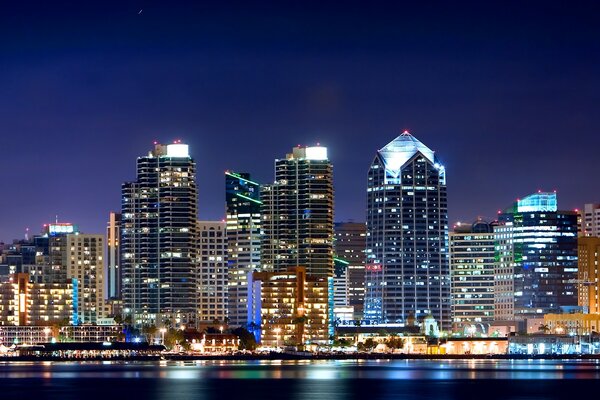 Evening city with tall houses with lighting