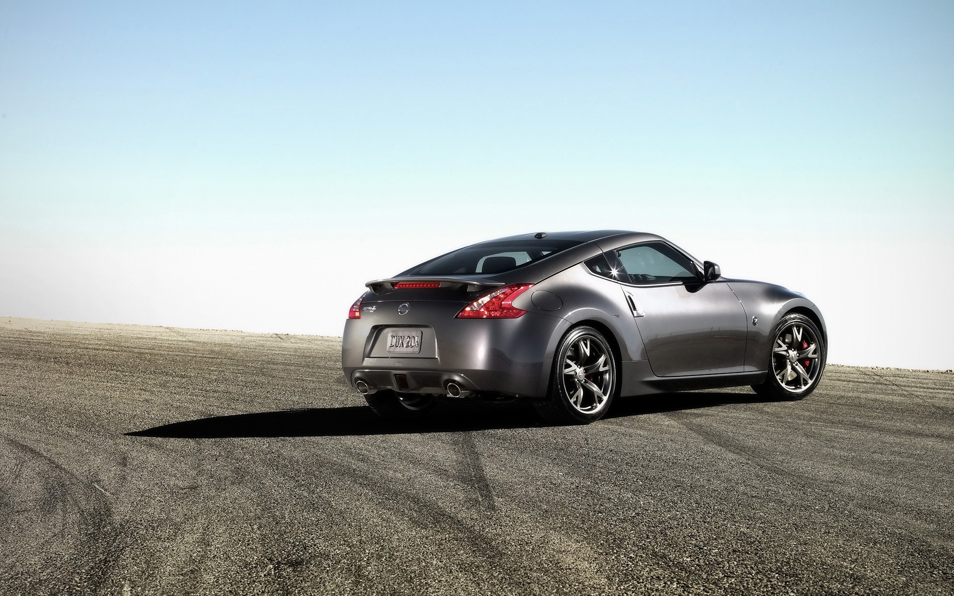 nissan car blacktop asphalt vehicle noon pavement hurry action wheel automotive nissan 370z