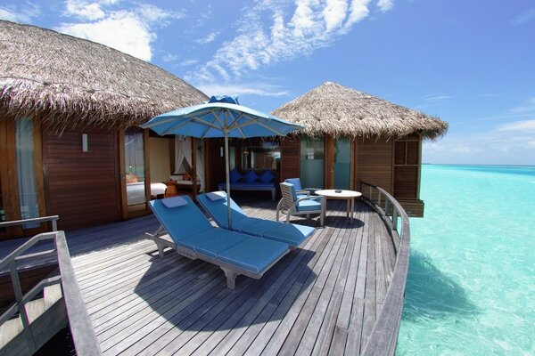 House by the sea with sun loungers at the resort