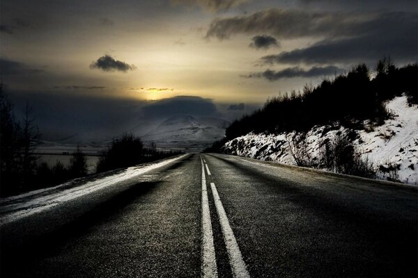 The road on the background of sunset in the mountains