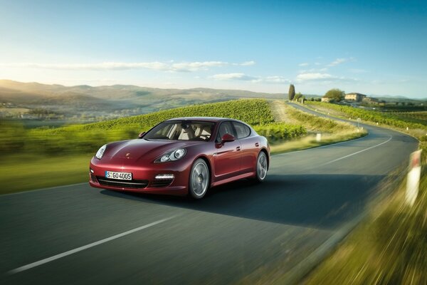 A Porsche at a tremendous speed is rolling over the horizon