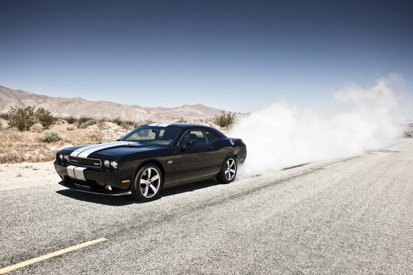 Dust from under the wheels of a cool car