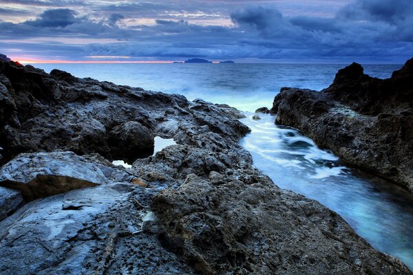 Cold sunset on the rocky ocean shore