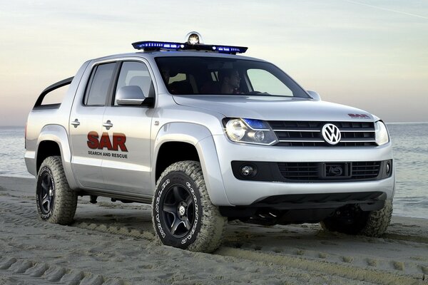 Volkswagen gris sur la plage de sable