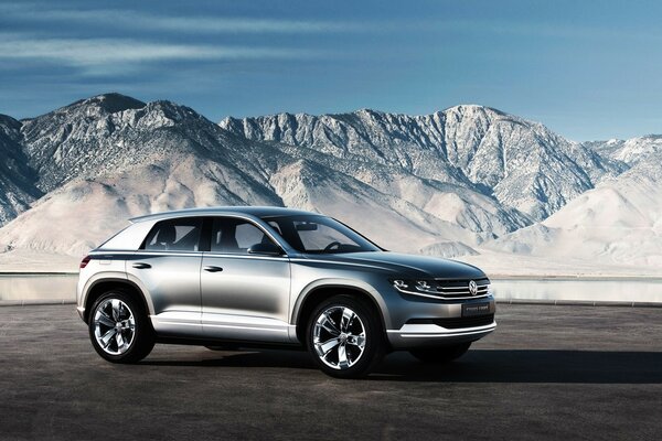 Silver car on the background of the grey mountains