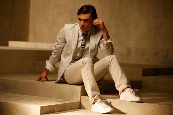 A handsome young man in a white suit