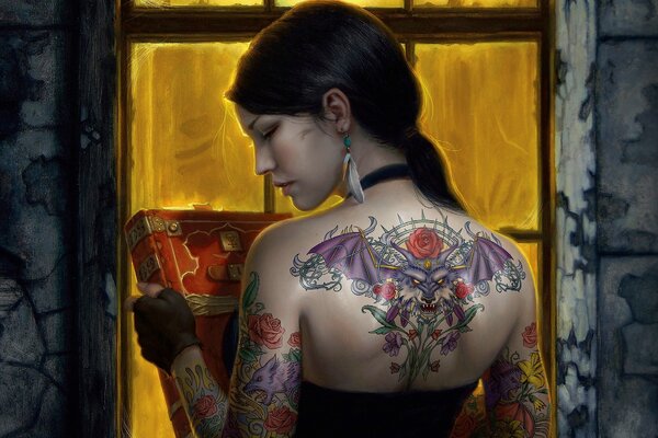 A girl with a tattoo on her back and a book in her hands