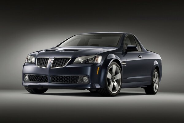 Dark blue Pontiac on a gray-black background