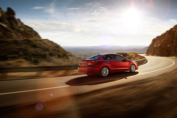 Red Subaru rushes towards the sun