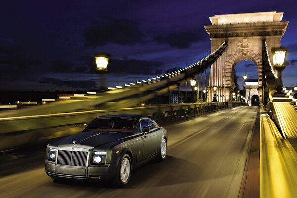 A beautiful rolls royce car is on the road