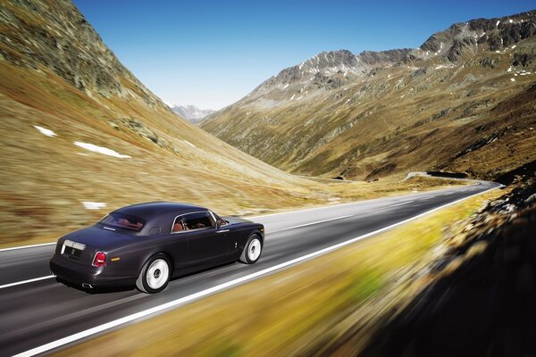 The car is approaching a turn on a mountain serpentine