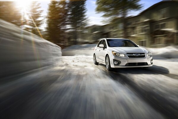 A white car on a blurry road