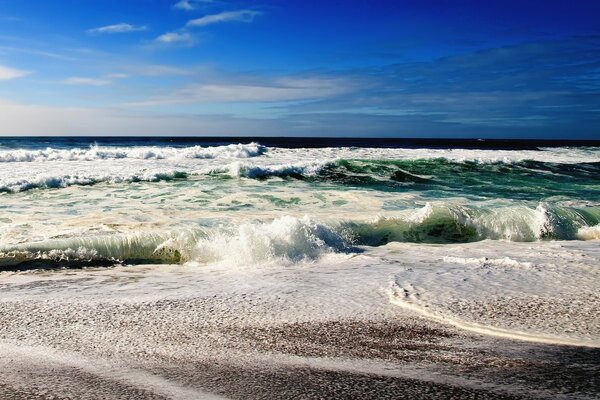 Sea waves on the sandy shore