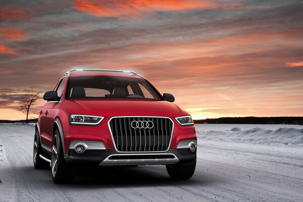 Red Audi car on a snowy road