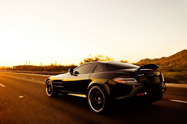 Black mercedes benz car rides on asphalt