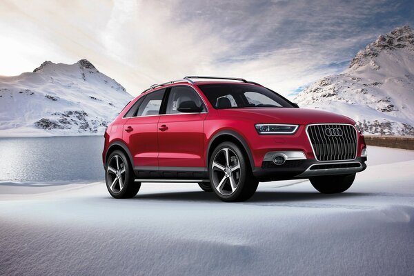 Red audi on the background of mountains