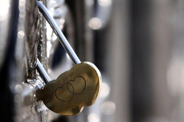 A love lock in the form of two glued hearts