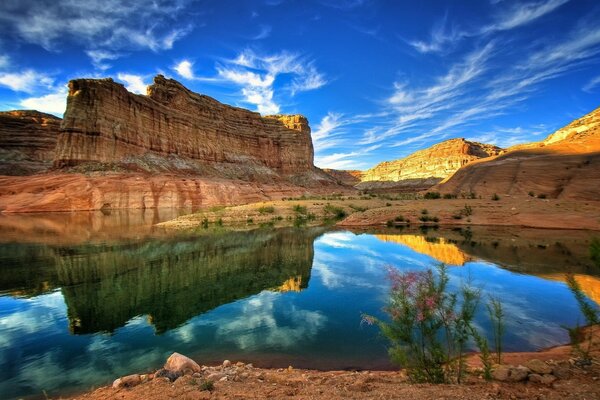 Blue lake in a canyon of rocks with prominent rock layers