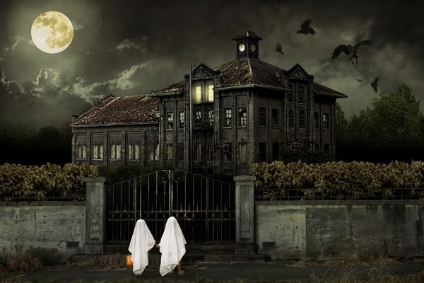 Halloween party on the background of a gloomy house and the moon