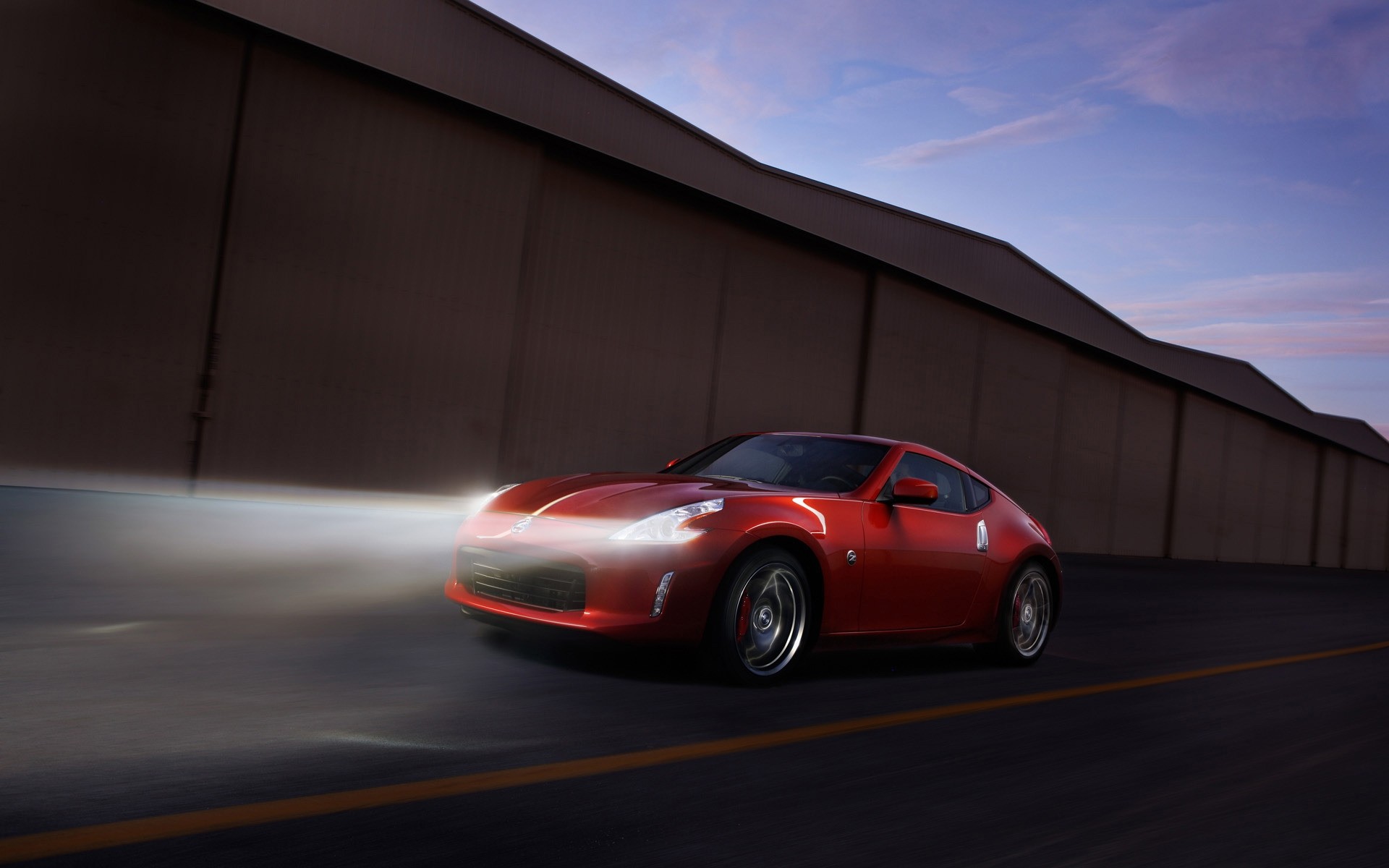 nissan car blacktop pavement vehicle asphalt blur hurry action noon automotive transportation system nissan 370z