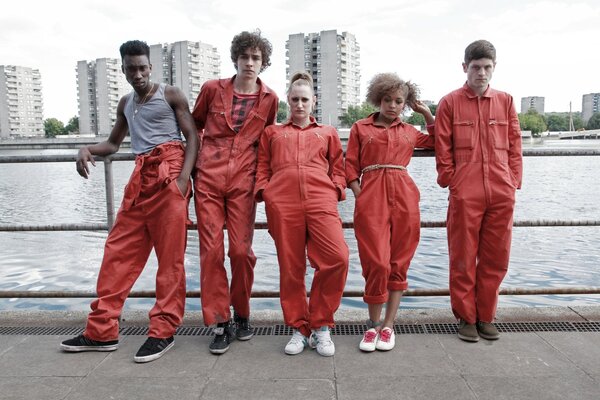 Five people in prison orange jumpsuits