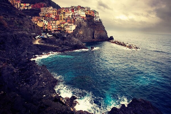 Sea surf at the foot of the cliffs with the city