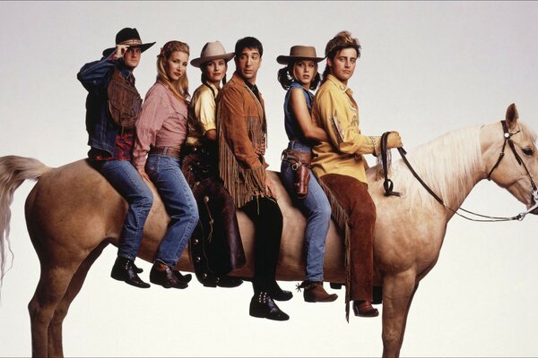 Several people are sitting on a white horse