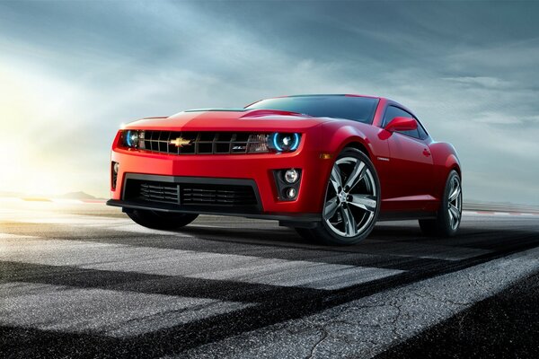 Red sports car on the sky background