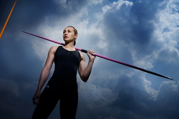 Javelin thrower against a cloudy sky