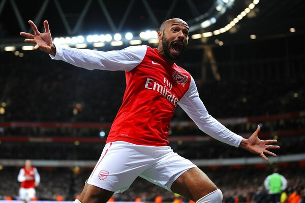 A football player with a beard splits his arms and shouts