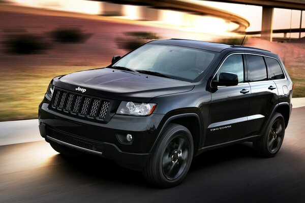 Jeep black at speed on the road