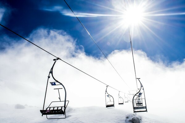 Nature winter ski lift in the mountains in the fog