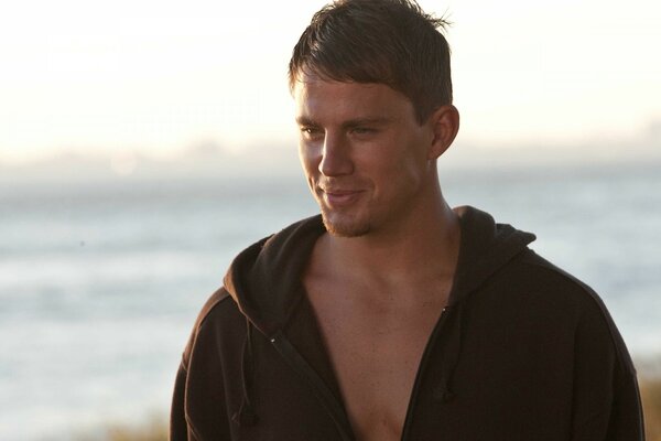 Actor on the background of the beach in black clothes