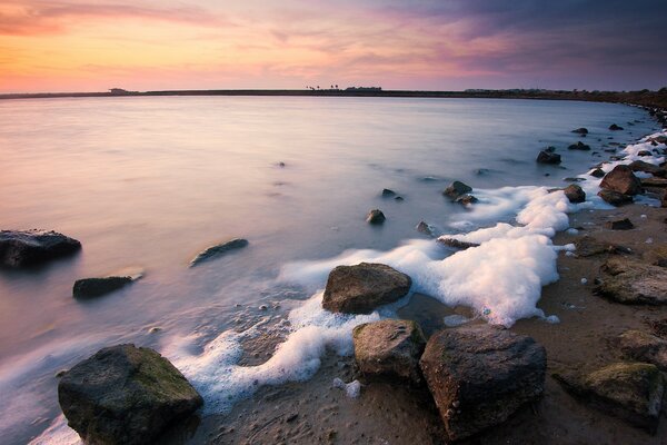 Seascape waves caressing coastal rocks