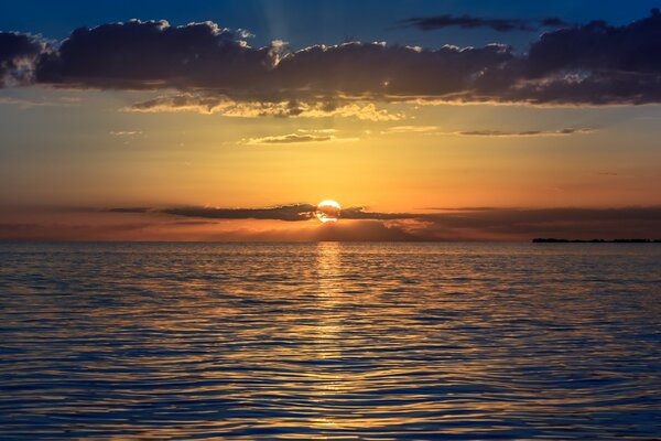 The rays of the setting sun gliding across the water surface