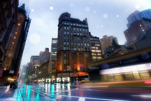 Evening street in the city, with illuminated houses and storefronts