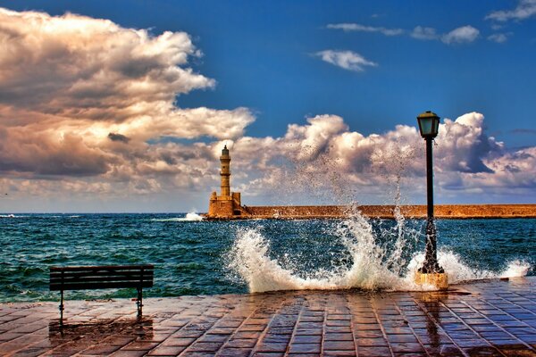 A beautiful landscape in the distance of a standing lighthouse in the middle of the sea