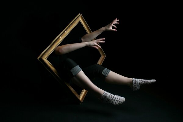 Hands and feet of a woman in a picture frame