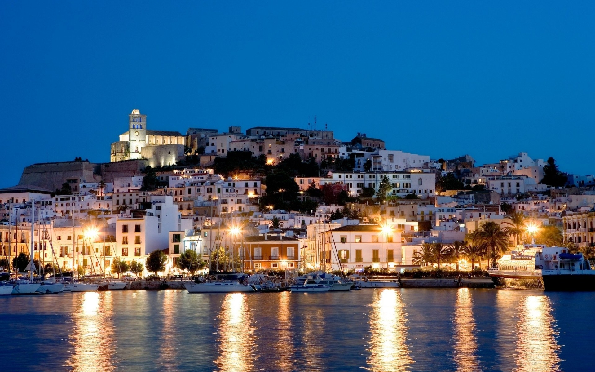 spain city water travel architecture cityscape town building river tourism church dusk evening reflection sky outdoors watercraft sea sight cathedral ibiza night ibiza landscape background night lights