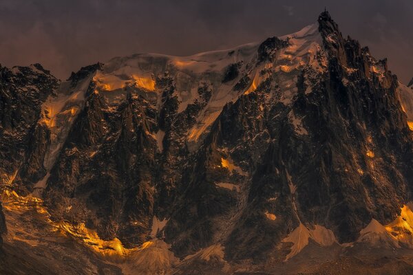 Sommet enneigé de la montagne au soleil couchant