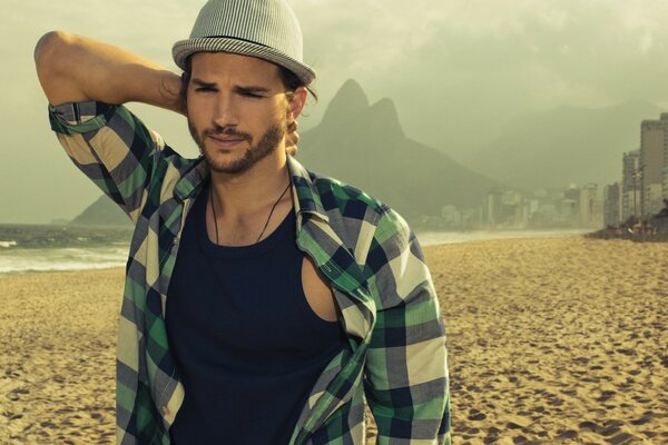 Man on the beach with a plaid shirt