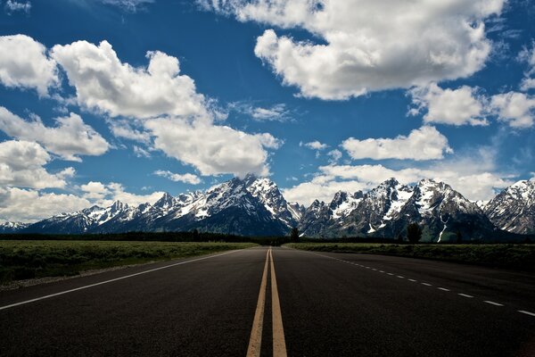 Landscape of mountain road and snow-capped mountains