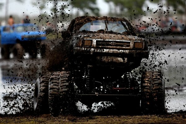 The SUV is covered in mud splashes