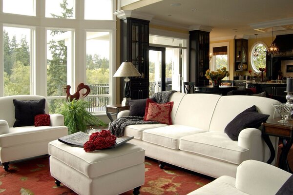 A respectable living room with a white sofa and armchairs
