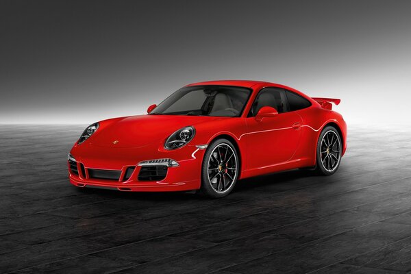 Gri masada kırmızı porsche modeli
