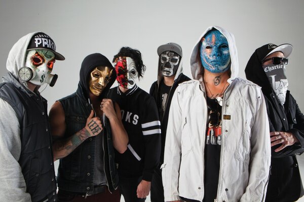 People from the music group wear masks