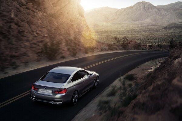 A beautiful car is driving on a mountain road