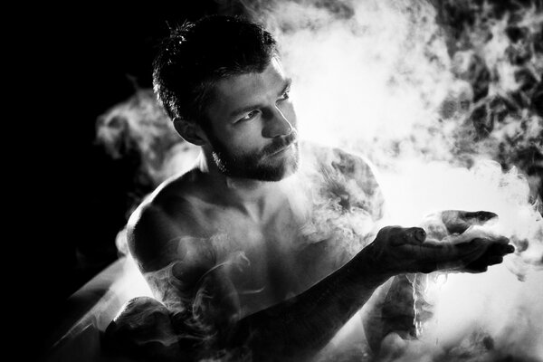 A man in smoke on a black background