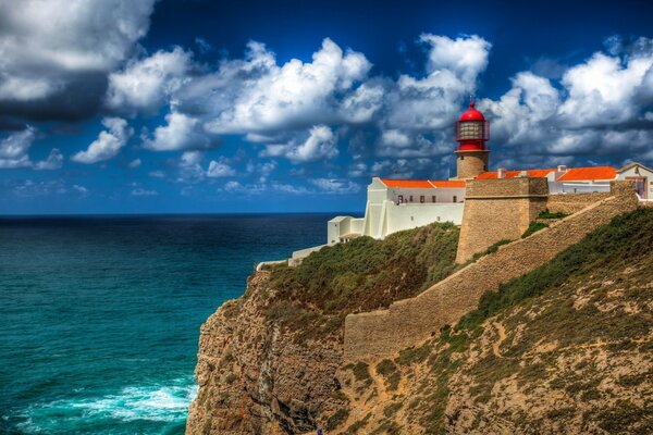 Lighthouse on the edge of an island surrounded by the sea