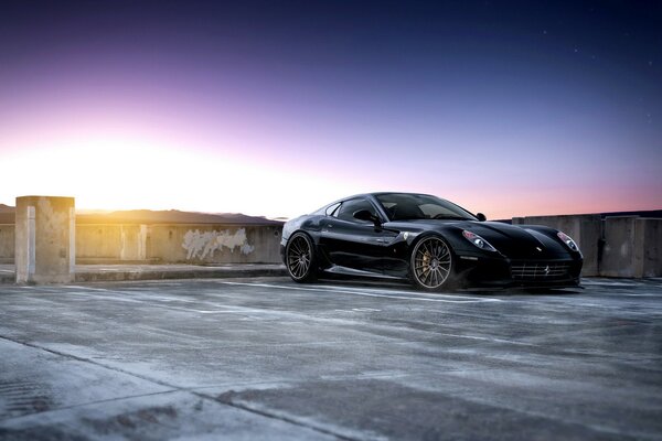 Black Ferrari on asphalt